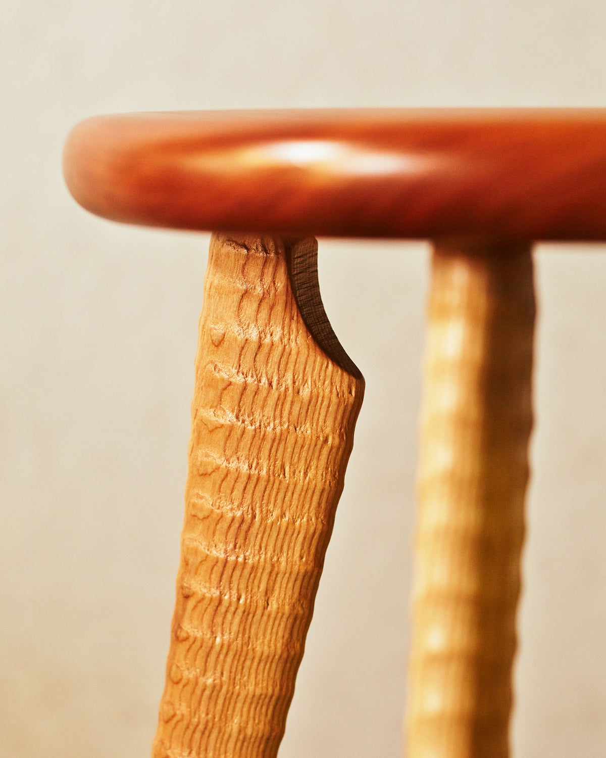 Detail of hand-turned ash ax handle leg mortised into cherry hardwood stool seat, Bradford Woodworking