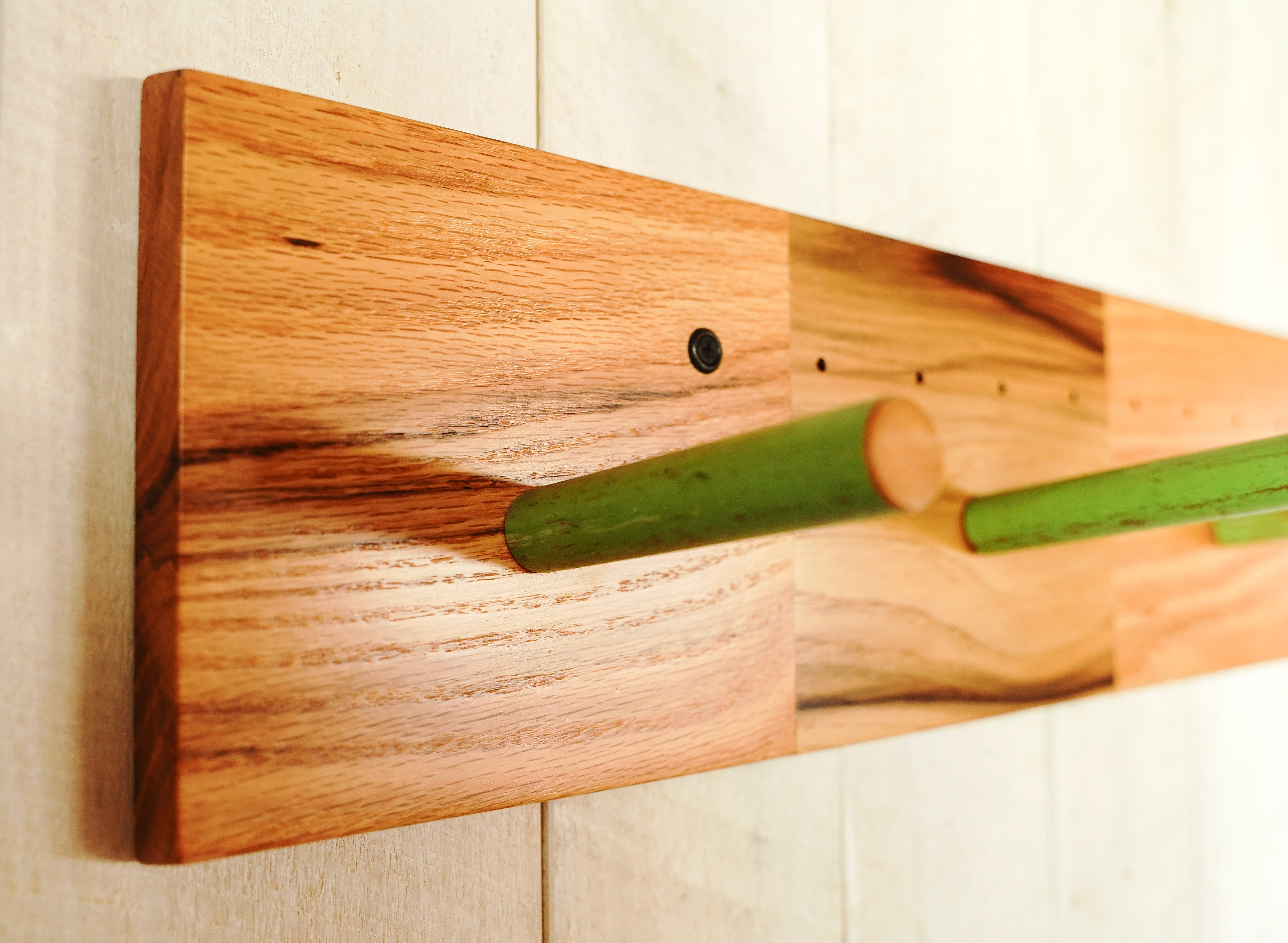 Close-up of a reclaimed antique broomstick peg mounted on an oak coat rack panel