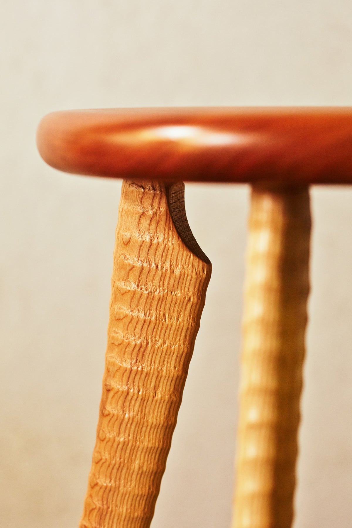 Detail of hand-turned ash ax handle leg mortised into cherry hardwood stool seat, Bradford Woodworking