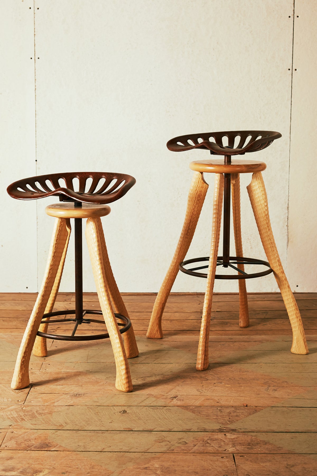Handmade farmhouse tractor seat counter stool and bar stool with cast iron seats and ax handle ash legs, Bradford Woodworking